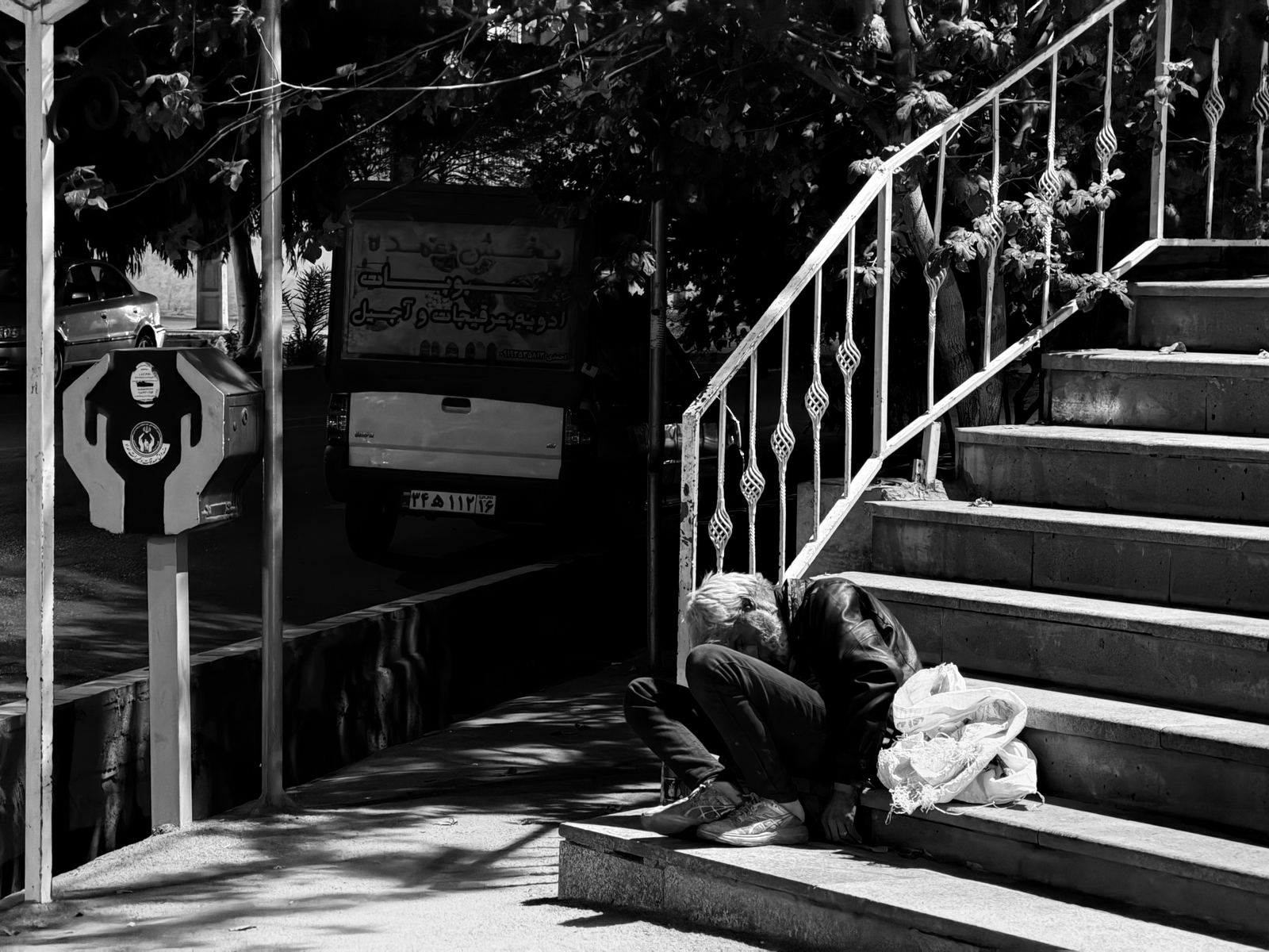 Homeless man sleeps in front of mosque